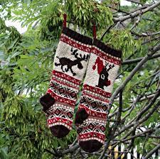 A picture of a person knitting christmas. Moose Fairisle Pattern Christmas Stockings Knit Pattern Fair Etsy In 2021 Christmas Stocking Pattern Knitted Christmas Stockings Christmas Stockings