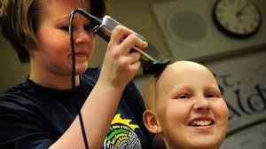Girl shaves head for fellow cancer patient