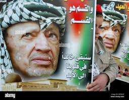 A Palestinian girl holds a banner of late Palestinian leader Yasser Arafat  during a demonstration calling for the release of Palestinian prisoners  held in Israeli jails, in the West Bank town of