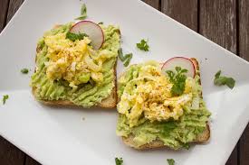 Two pieces of bread with avocado and radishes on them. Avocado ...