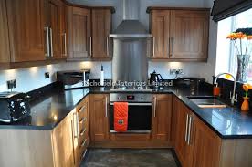 wood kitchen with black worktops