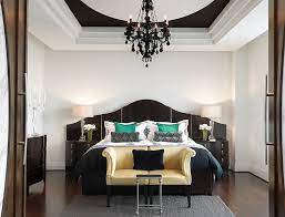 A black wrought queen size bed with shaggy and printed decorative pillows acts as the focal point of this charming haven. Bold Black And White Bedrooms With Bright Pops Of Color