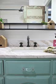 This 1952 farmhouse makeover kept the traditional farmhouse elements of subway tile, classic pulls and simple cabinets and added a stunning geometric floor that looks modern but also has a vintage feel. Farmhouse Bathroom Remodel Sources Lolly Jane