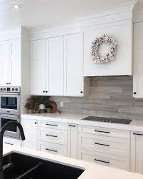 White shaker cabinets with copper/rose gold hardware, white subway tile backsplash and open shaker white kitchen cabinet hardware ideas by our house blog. White Kitchen Black Hardware Hmdcrtn