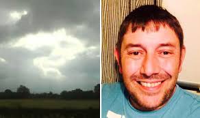 Man photographs a perfectly shaped question mark cloud