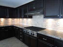 This kitchen belongs to iron chef jose garces, and also has dark cabinets and an unlacquered brass backsplash. Likable Dark Kitchen Cabinets Backsplash Ideas Brown White Design Layjao