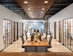 This modern, rustic home office features an open desk used to create a large work area without taking up much visual weight. Iron Age Office All Products Industrial Office Design Industrial Modern Office Office Design