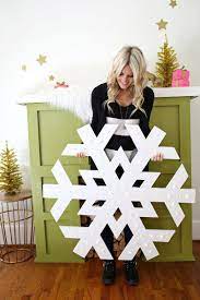I had hoped to also put a new twist on this year's post by making our snowflakes out of pretty wrapping paper instead of regular copy or construction paper. Giant Snowflake Light Up Marquee A Beautiful Mess Diy Christmas Snowflakes Christmas Snowflakes Snowflake Lights