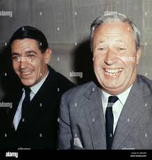 Circa 1965, London, England, United Kingdom: Sir EDWARD HEATH KG MBE (R)  shares a laugh during a press event in London. Often known as Ted Heath, he  was a British politician who