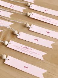 Form the shape of a christmas tree with envelopes in various sizes, and mark each with adhesive numbers. Wedding Advent Calendar Entertain The Idea