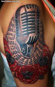 People are so crazy about music tattoo that they love to get their microphone tattoos as well. Tattoo Of Microphones Roses Scores