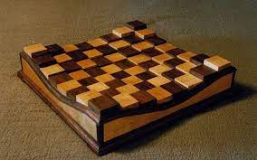 This chess board is designed for the intermediate woodworker and can be built with just a table overall dimensions of finished product are 17in x 17in x 4.75in this is not a kit, it is the paper plan only. Raised Chess Board Chess Board Wood Projects For Beginners Chess