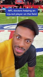 NFL Doctor Assisting Injured Player During Football Game