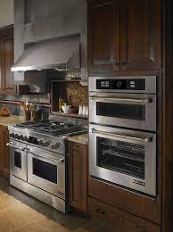 There S No Choice But To Be Envious Of This Flawless Kitchen The Dark Cabinetry Pairs Perfectly With The Je Kitchen Design Kitchen Appliances Oven Wall Oven