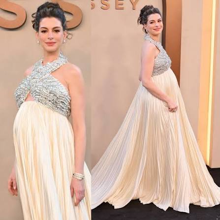 Anne Hathaway skipped the dramatic and playful route, choosing instead a  perfectly balanced approach. In a gorgeous custom Prada evening gown, she  looked noble and elegant, with her pregnant beauty subtly and