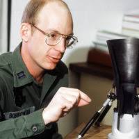 Lt. Cmdr. Jonathan Auten, the emergency medicine residency assistant  director and emergency medicine physician at Naval Medical Center  Portsmouth, demonstrates proper infant CPR to Honduran doctors and nurses. 