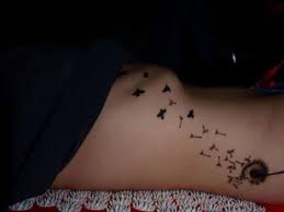 On top of the dandelion, its wings are drawn flying out of it flying toward some birds in a line. 150 Meaningful Dandelion Tattoo Ideas