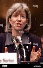 U.S Interior Secretary Gale Norton, left, along with her newly appointed  staff members, Drue Pearce, center left, and Cam Toohey, far left, talks  with Arctic Village's chief Evon Peter, right front, and