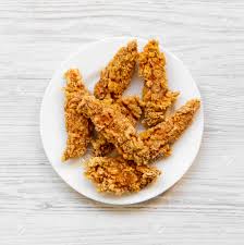 Don't forget to pick a dipping sauce! Spicy Chicken Strips On White Plate Over White Wooden Background Stock Photo Picture And Royalty Free Image Image 106545277