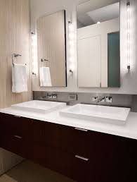 Bathroom Light Fixture With Outlet Plug With Contemporary Bathroom And Bathroom Hardware Bathroom Lighting Bathroom Mirror Double Sinks Floating Vanity Minimal Neutral Colors Shared Bathroom Square Sinks Towel Bar Wall Mount Faucet