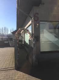 The main room features a stage for live music, comfortable lounge furniture and elevated bar seating. Haus Mona