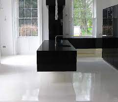 Did you know that everlast natural stone is not just for patios and garages?it is also great for basements, family rooms, game rooms, utility rooms or, becau. Ultra Modern Gloss Black Floating Cantilevered Kitchen With Pure White Seamless Resin Floor Modern Flooring Interior Light Fixtures Flooring
