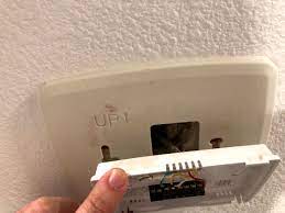 Remove a basic thermostat cover by hooking your fingers under the outside plastic ring and pulling it straight out toward you. How To Remove The Wall Plate Behind Honeywell Thermostat Home Improvement Stack Exchange