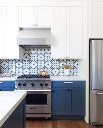 White and blue moroccan style floor tiles in a contemporary kitchen featuring a blue vaulted ceiling and accents of cobalt blue glassware. These Mexican Tile Backsplash Ideas Are The Antidote To Snooze Worthy Kitchens Hunker Moroccan Tile Backsplash Modern Kitchen Backsplash Moroccan Tiles Kitchen