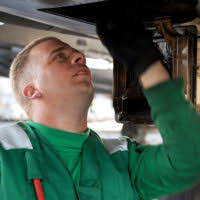 U.S. Navy CHIEF Aviation Machinist's Mate Bruce Boyle and Aviation  Machinist's Mate 1ST Class Steven Neitz, both assigned to Patrol Squadron  (VP) 16, reference a technical manual while installing an auxiliary power