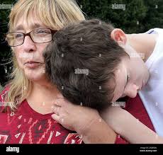 Richard Glossip's sister, Nancy Ogden, left and her grandson Kevin Glossip  embrace outside Oklahoma State Penitentiary in McAlester, Okla., Wednesday,  Sept. 30, 2015. Oklahoma Gov. Mary Fallin postponed at the last minute