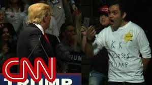 Trump stares down man in 'KKK' shirt ...