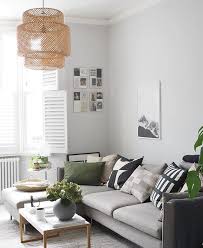 Light Scandi Style Living Room With Pale Grey Walls A L Shaped Grey Sofa And Green Details Green Cushions Living Room Living Room Grey Green Living Room Decor
