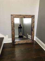 The sloped moulding creates a contemporary look that fits well with other wall displays. Jacobean Mirror Wood Framed Mirror Handmade Rustic Wood Etsy In 2021 Mirror Wall Wood Framed Mirror Wood Mirror
