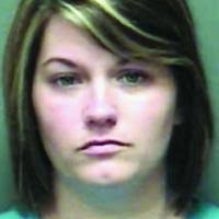 Murder suspect's wife arrested