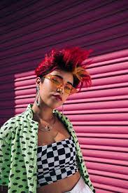 Stuck on how to style your short hair? Young Generation Z Woman With Multicolored Hair Wearing A Cool Fashion Outfit In Front Of A Pink Wall Generation Z Multicolored Hair Women
