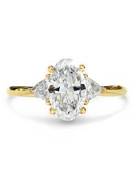 The center stone is flanked on both sides with the same shape and cut side stones. Unique Oval Diamond 3 Stone Engagement Ring With Side Stones Unique Engagement Rings Nyc Custom Jewelry By Dana Walden Bridal
