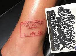 Red Tattoo Passport Stamp By Bali Star Ink Make Mine Say 3018 Pleaseandthankyou Red Tattoos Trip Tattoo Red Ink Tattoos