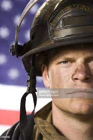 Portrait Of A Firefighter With Us Flag Firefighter Photography Firefighter Male Senior Pictures