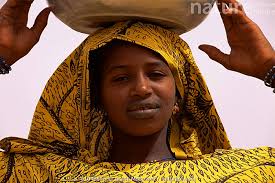 Stock photo of Portrait of Falani woman in traditional clothing, with bowl 