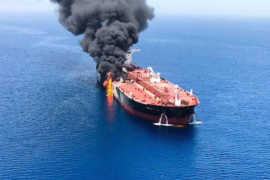 An aerial view of an oil tanker navigating the narrow shipping lanes of the Strait of Hormuz.