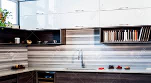If an all white, super contemporary kitchen design is too much for your taste (or you can't trust yourself to keep it looking spotless) consider opting for. Contemporary Kitchen Design In 3 Verschiedenen Stilrichtungen Weisse Kuchenschranke Braune Kuchenschranke Und Offene Regale Mit Unterschrankbeleuchtung Lizenzfreie Fotos Bilder Und Stock Fotografie Image 73932667