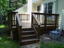 Dark Brown Deck With Yellow House Deck Pictures House Deck Backyard Makeover