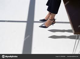 Woman Dangling Her Feet Desk Stock Photo by ©ImageSource 320480986
