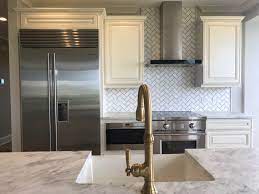 While you often see backsplash tile only reaching up to the upper cabinets, it looks all kinds of fabulous to take it up to the ceiling. 10 Kitchen Backsplashes That Go Above And Beyond Florida Design Works