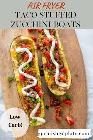 This delicious dish tastes like a savory and spicy taco, but the zucchini boat replaces the tortilla. Air Fryer Taco Stuffed Zucchini Boats Garnished Plate