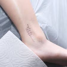 Small Grass Flower Tattoo On The Ankle Tattoos Flower Tattoo On Ankle Dainty Tattoos