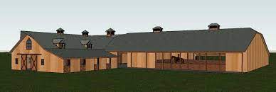 Decloet indoor riding arena with fabric roof with attached barn. Horse Arenas