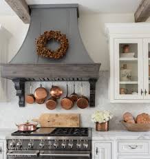 And if you're envisioning a space that holds so many points of interest, you'll need to know the necessities. Farmhouse Kitchen With Fall Decorating Glass Front Cabinets With Copper Accents Range Hood With Wreath Farmhouse Kitchen Decor Farmhouse Kitchen Home Decor