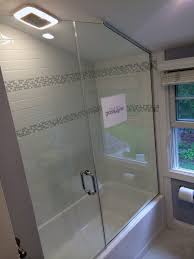 A Simple Frameless Shower Door Installed Above A Tub And Butting A Panel Attached To A Sloped Ceiling Frameless Shower Doors Door Installation Shower Doors