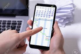 Close Up Of A Persons Hand Analyzing Gantt Chart On Cellphone